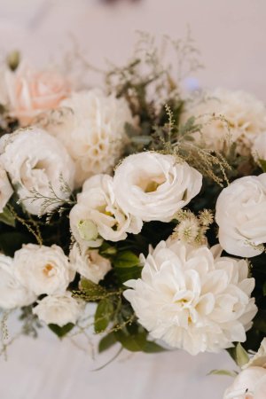 close up of white and pink flowers with greenery